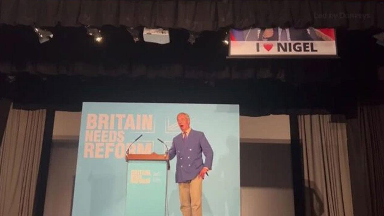 Nigel Farage Speech Interrupted by Banner Making Putin Views in UK